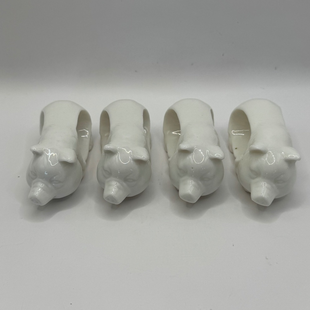 Set of 4 vintage white porcelain pig napkin rings.